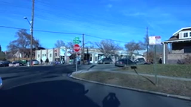 DENVER COLORADO-2015: Tan Building And Red Stop Sign On A Clear Sunny Day