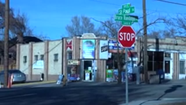 DENVER COLORADO-2015: Several Stores Next To A Street With A Cop Car Passing
