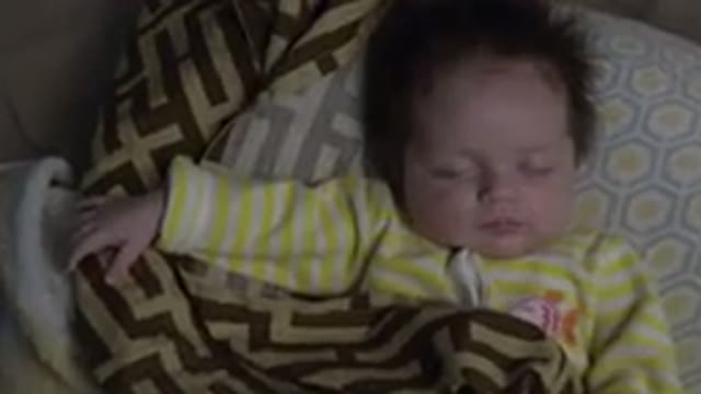 WESTMINSTER COLORADO-2015: Baby Wearing Yellow Shirt Sleeps Under Brown and Tan Blanket