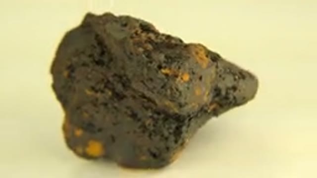 WESTMINSTER COLORADO-2015: Brown Rock With Gold Linings On A Table Spinning