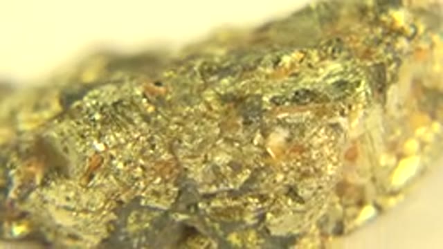 WESTMINSTER COLORADO-2015: A Gold and Crystal Solid Rock Laying on a Hard Surface