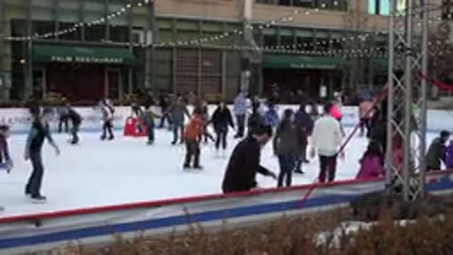 WESTMINSTER COLORADO-2015: People Skating on Ice Rink with Wall in Background