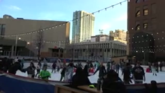 WESTMINSTER COLORADO-2015: People Skating On Ice In The Middle Of A Big City
