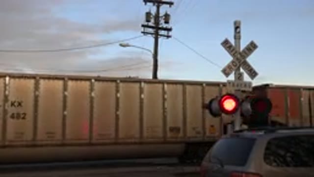 WESTMINSTER COLORADO-2015: Freight Train Passing By At A Railroad Crossing With