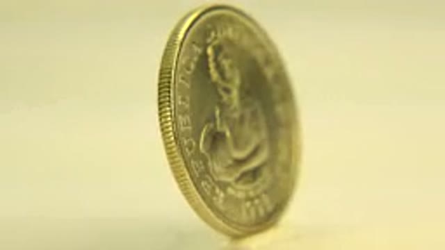 WESTMINSTER COLORADO-2015: A Golden Coin With Design Of Woman Holding An Object