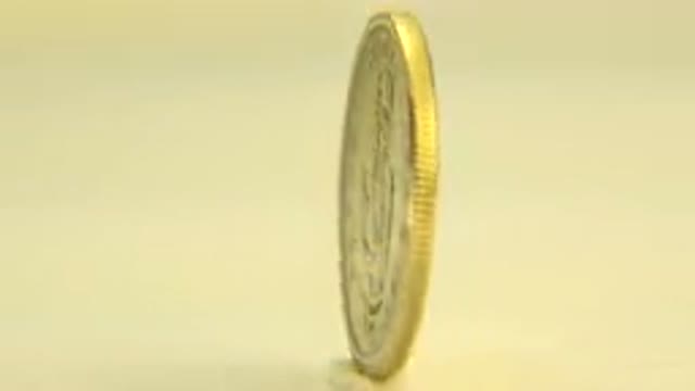 WESTMINSTER COLORADO-2015: Slow Rotating Gold Coin Under A White Light