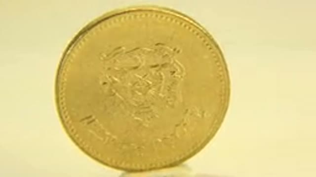 WESTMINSTER COLORADO-2015: Rotating Gold Doubloon Coin Under a White Light