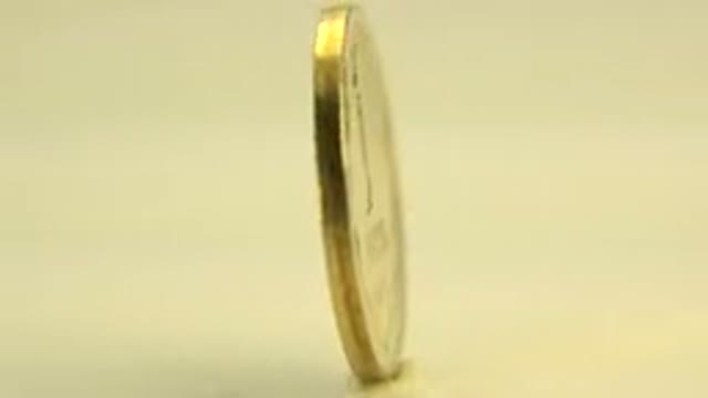 WESTMINSTER COLORADO-2015: A Close-Up Recording Of A Golden Coin That Is Spinning