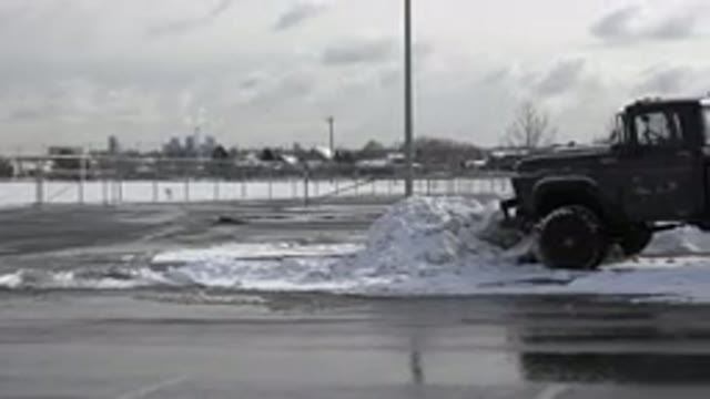 WESTMINSTER COLORADO-2015: A Dark Truck With Large Tires Parked On A Snow Covered Street
