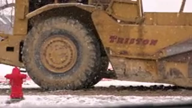 WESTMINSTER COLORADO-2015: Parked Yellow and Green Tractors in Snowstorm