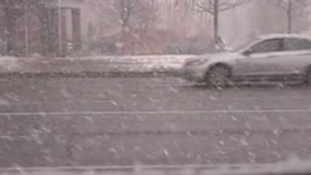WESTMINSTER COLORADO-2015: Traffic Driving By In A Snowstorm A Person Walking