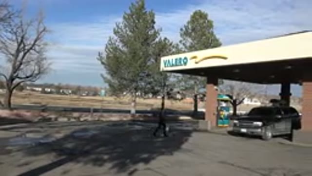 DENVER COLORADO-2015: Cars Are Fueled At A Gas Station By The Roadside
