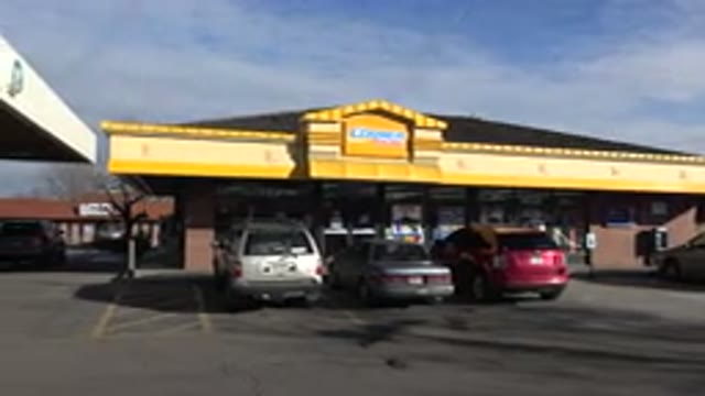 DENVER COLORADO-2015: Store Front Next To A Gas Station With Cars Parked