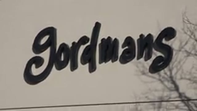 DENVER COLORADO-2015: Camera Zooms Out Of Gordian Sign Atop A Green Pergola As