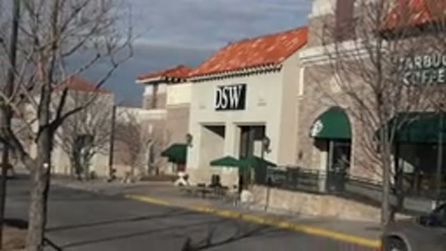 DENVER COLORADO-2015: Car Driving Past Starbucks Sign On A Sunny Day