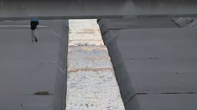 WESTMINSTER COLORADO-2015: Man Running Under Cement Bridge Next To A Canal