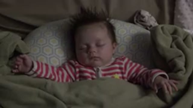 WESTMINSTER COLORADO-2015: Baby Boy Sleeping Covered With A Green Blanket