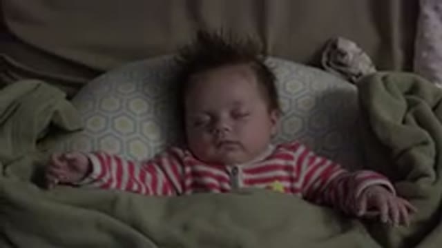WESTMINSTER COLORADO-2015: A Baby Sleeping With Its Arms Spread In A Chair