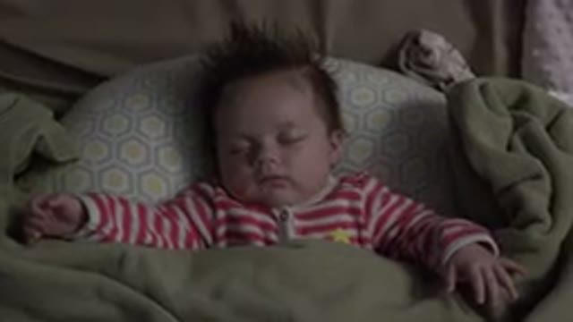 WESTMINSTER COLORADO-2015: A Baby With Wild Hair Is Wearing Striped Pajamas And Asleep In Bed