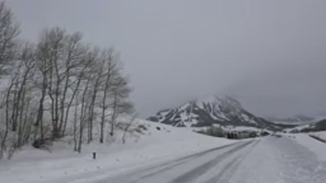 CRESTED BUTTE COLORADO-2015: A Snowy Road in the Winter with Mountains and Trees