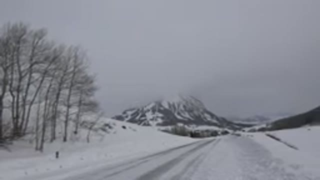 CRESTED BUTTE COLORADO-2015: Road With Mountains And Snow And Cloudy Day