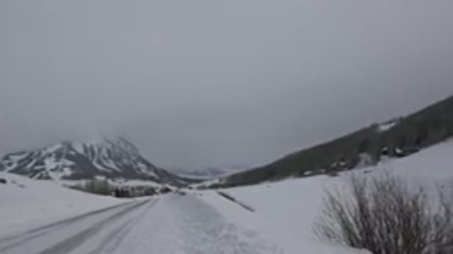 CRESTED BUTTE COLORADO-2015: Empty Road Between Mountains and Snow-Covered Trees