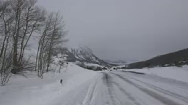 CRESTED BUTTE COLORADO-2015: Snow Covered Mountain And Road On A Cloudy Day