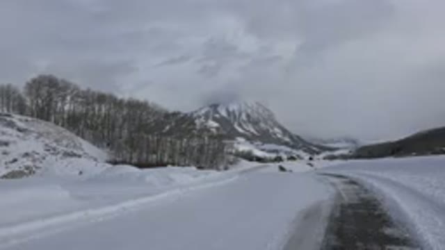 CRESTED BUTTE COLORADO-2015: Snow Path Road With An Icy Mountain Scene Afar