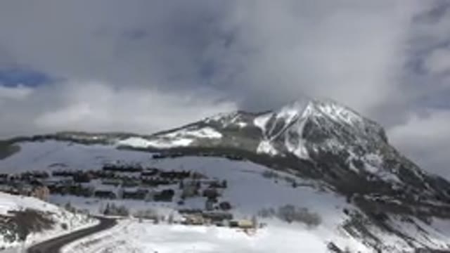 CRESTED BUTTE COLORADO-2015: Panning Snow-Covered Mountain With Winding Road