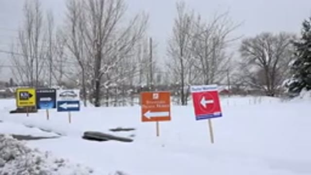 ARVADA COLORADO-2015: Five Colorful Road Signs Installed On A Road Covered in Snow