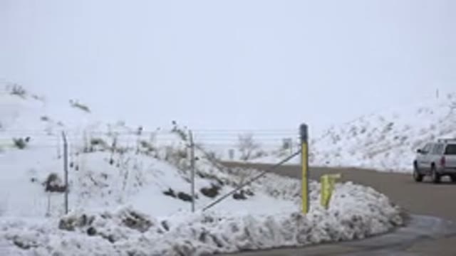 ARVADA COLORADO-2015: A Road Surrounded By Snow And A Grey SUV Parked On The Side