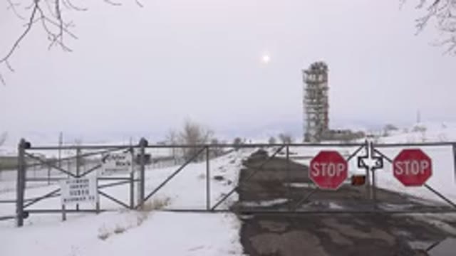 ARVADA COLORADO-2015: Gated Area With Stop Signs On Gates Fencing Off Tall Buildings
