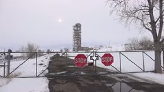 ARVADA COLORADO-2015: Snowy Gated Road With Building In Background
