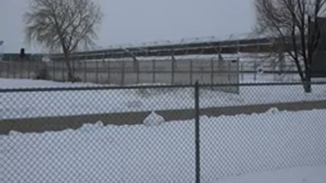 ARVADA COLORADO-2015: Snow Covered Fields And Chain Link Fence On A Cloudy Day