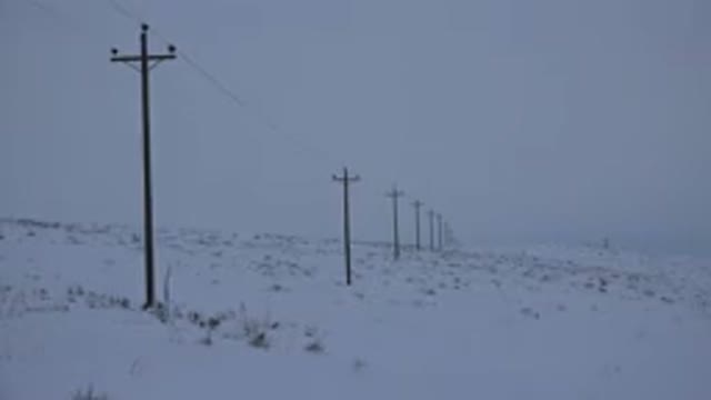 ARVADA COLORADO-2015: Telephone Poles in Snow-Covered Field on a Cloudy Day