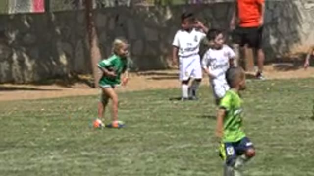 SAN JOSE DEL CABO MEXICO-2019: Girl Wearing Green Shirt With Green And Orange Shoes Running On Grass