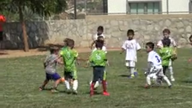 SAN JOSE DEL CABO MEXICO-2019: Happy Little Kids Playing Soccer On A Grass Field