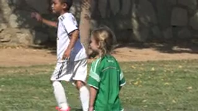 SAN JOSE DEL CABO MEXICO-2019: Kids In Green And White Jerseys Playing Soccer On A