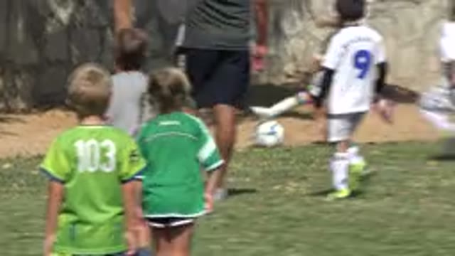 SAN JOSE DEL CABO MEXICO-2019: Kids On A Grass Field With Stone Walls Playing Soccer