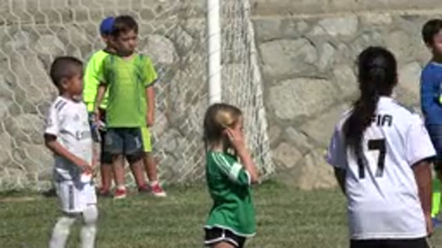 SAN JOSE DEL CABO MEXICO-2019: Little Kids Playing Soccer On Grass With Their Coach