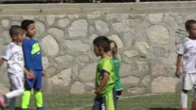 SAN JOSE DEL CABO MEXICO-2019: Kids Playing Soccer On A Grass Field With Coach