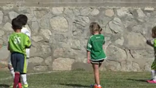 SAN JOSE DEL CABO MEXICO-2019: Boy Wearing White Shirt Picks Up Black and White Object