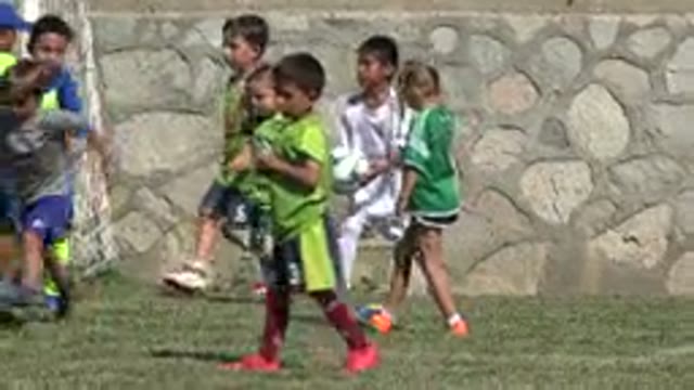 SAN JOSE DEL CABO MEXICO-2019: Little Children Play Soccer Game On Grass Green