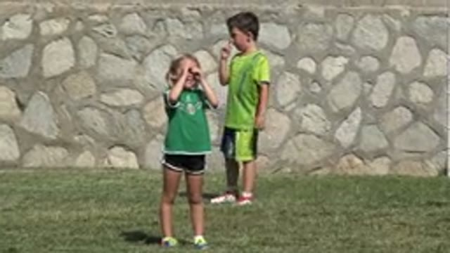 SAN JOSE DEL CABO MEXICO-2019: Two Little Children in Green T-Shirts Playing Soccer