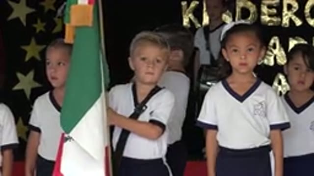 SAN JOSE DEL CABO MEXICO-2019: Boy Wearing White And Black Shirt Holds Green Object