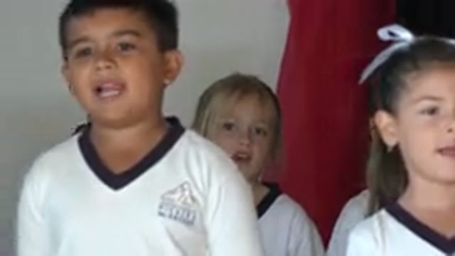 SAN JOSE DEL CABO MEXICO-2019: Group of Kids Wearing White Shirts Stand Near Red Object
