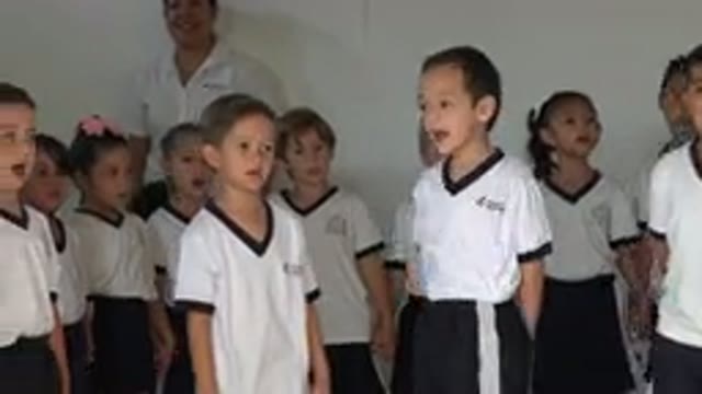 SAN JOSE DEL CABO MEXICO-2019: Group Of Kids Wearing White Shirts Singing For