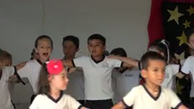 SAN JOSE DEL CABO MEXICO-2019: Kids Wearing Black And White Shirts Sing With Linked Arms