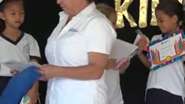 SAN JOSE DEL CABO MEXICO-2019: Little Girls In School Uniforms Discuss Their Certificates