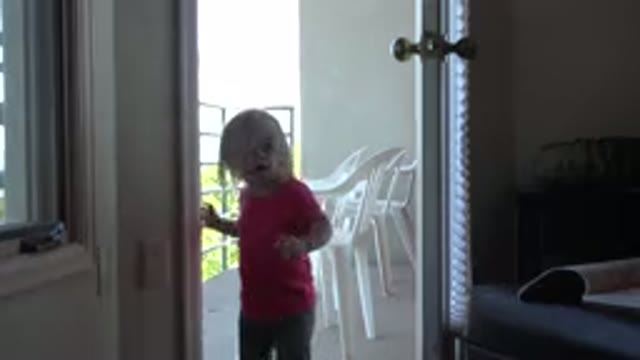 MESA COLORADO-2016: Girl Wearing Red Shirt Walks Through An Open White Door